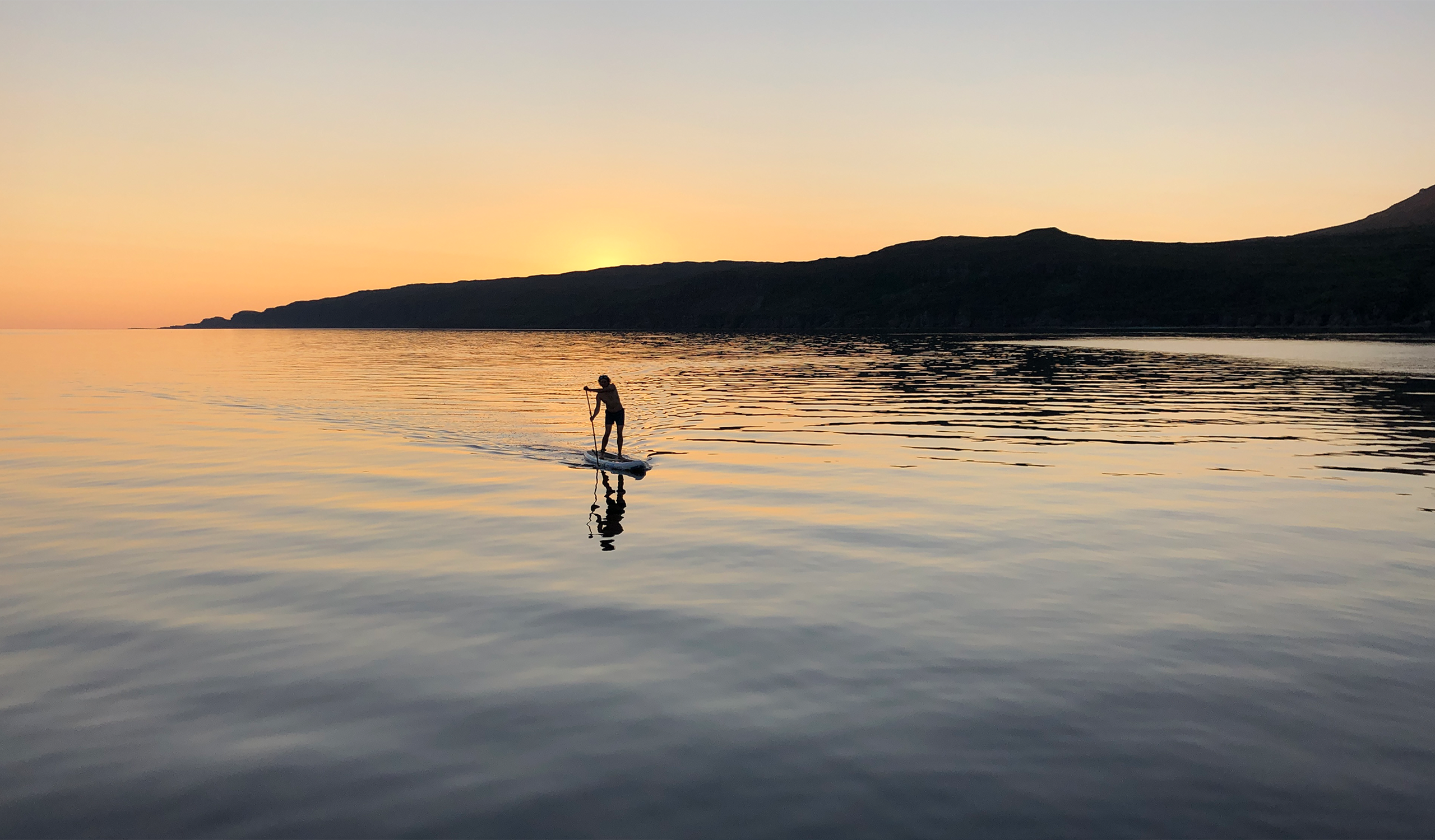 standup paddle board at sunset